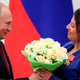 Russian President Vladimir Putin presents flowers to editor-in-chief of Russian state broadcaster RT, Margarita Simonyan, at the Kremlin in Moscow on May 23, 2019.
